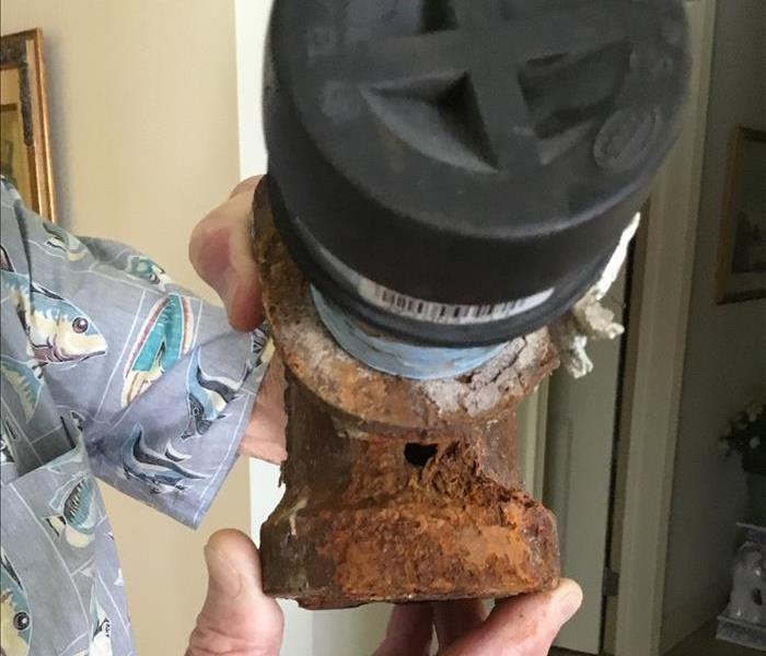 rusted pipe with hole in it