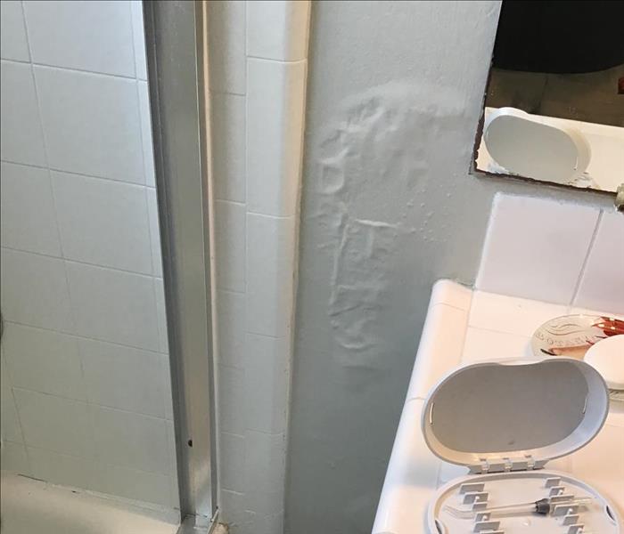 Bubbled wall in bathroom from hidden leak