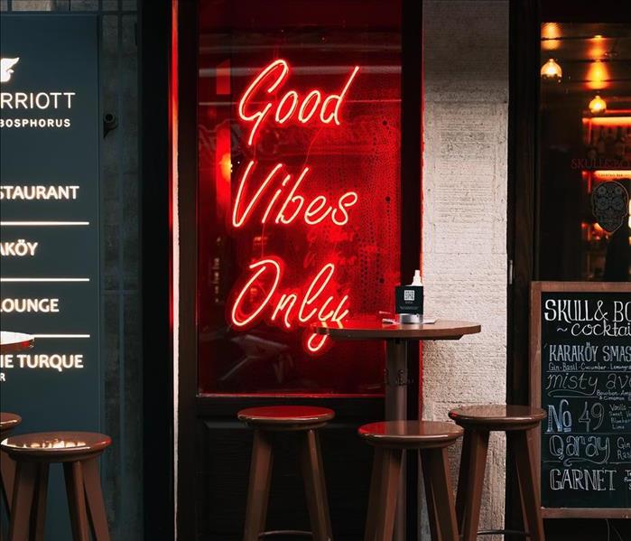 neon sign reading "good vibes only" in storefront 